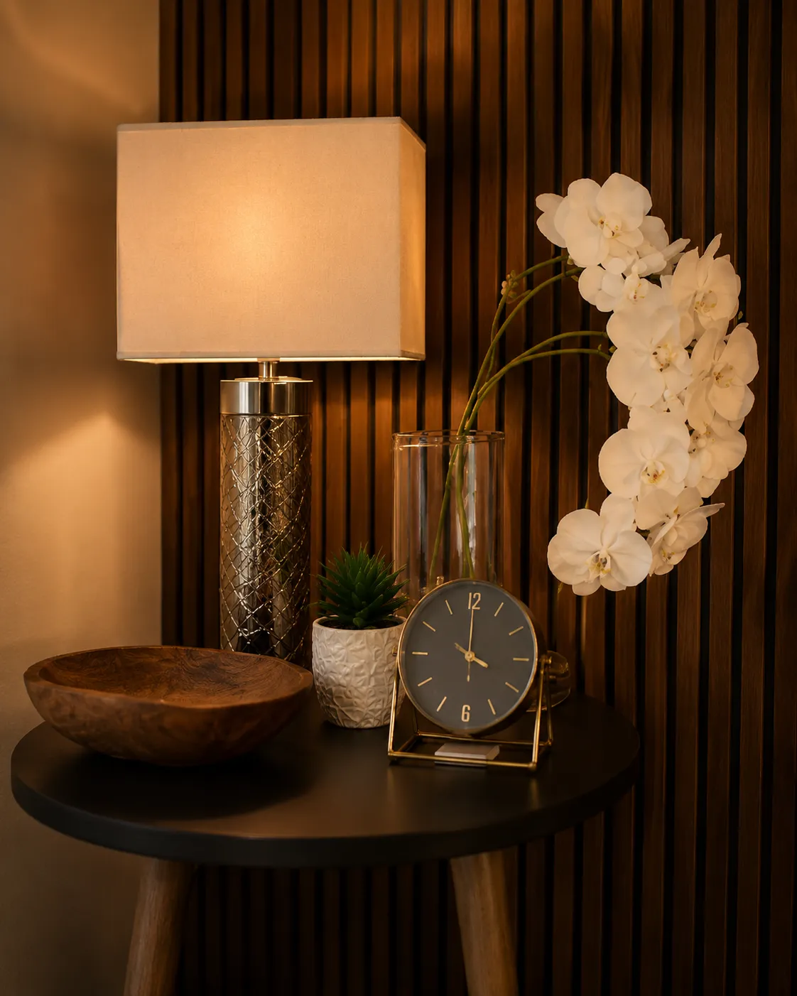 Side table with a clock, plant and orchids in a Phoenix therapy office
