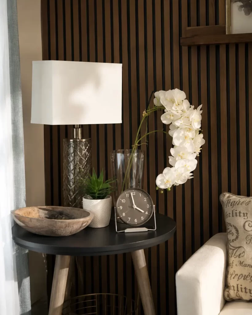 Side table with a lamp, orchids and a clock in the Clearwater Counseling office in Phoenix