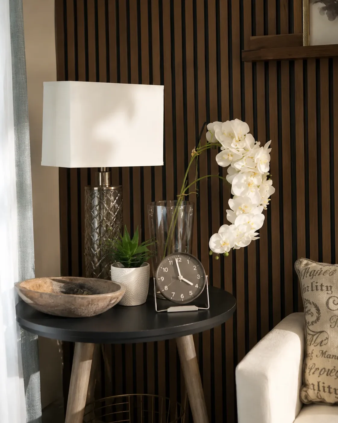 Side table with a lamp, orchids and a clock in the Clearwater Counseling office in Phoenix